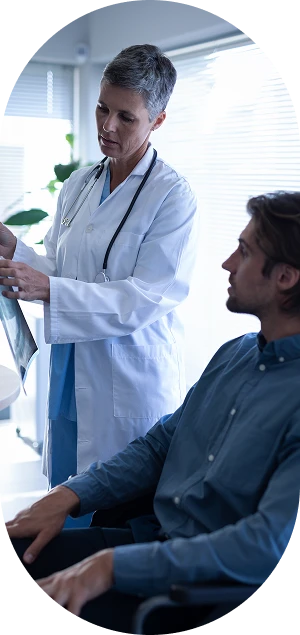 Mature Female Doctor Showing Xray Report Patient Clinic